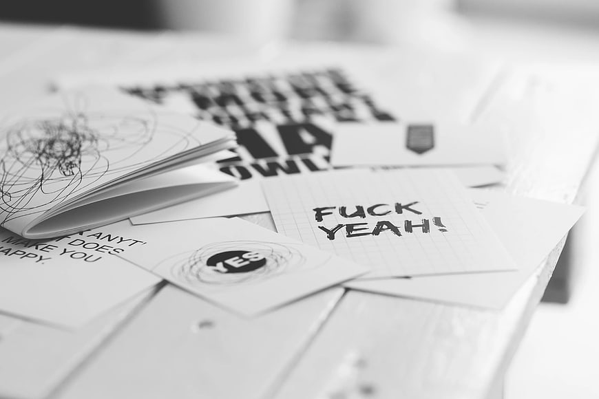 Black and white greeting cards with handwritten text on table