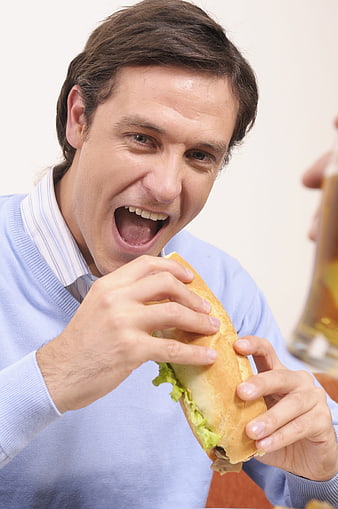 Hungry Businessman About To Take A Bite Of A Large Sandwich
