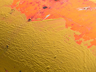 Close-up of distressed yellow and orange painted metal texture
