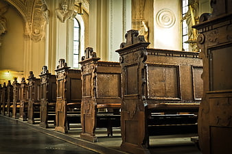 Ornate wooden pews in a historic baroque church interior