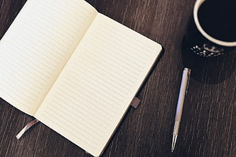 Open Notebook, Pen, and Coffee on Dark Wood Desk