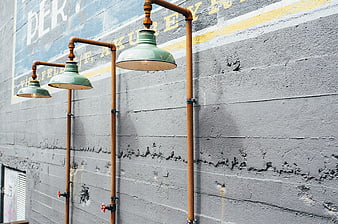 Industrial Pipe Lamps on Textured Concrete Wall