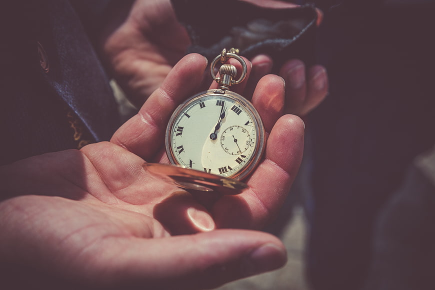 Vintage pocket watch held in hand