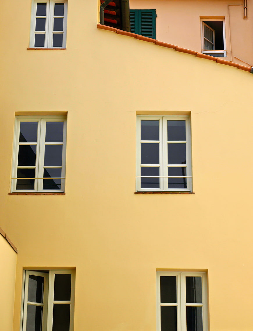Yellow Building Facade with White Windows
