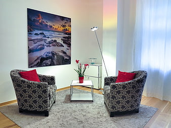 Modern Therapy Room Interior With Patterned Armchairs And Red Cushions
