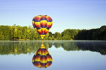 Colorful Hot Air Balloon Reflecting in Calm Lake