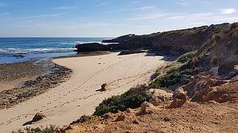 Sandy Beach Cove with Rocky Cliffs and Blue Ocean