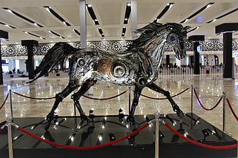 Metallic mechanical horse sculpture in modern lobby