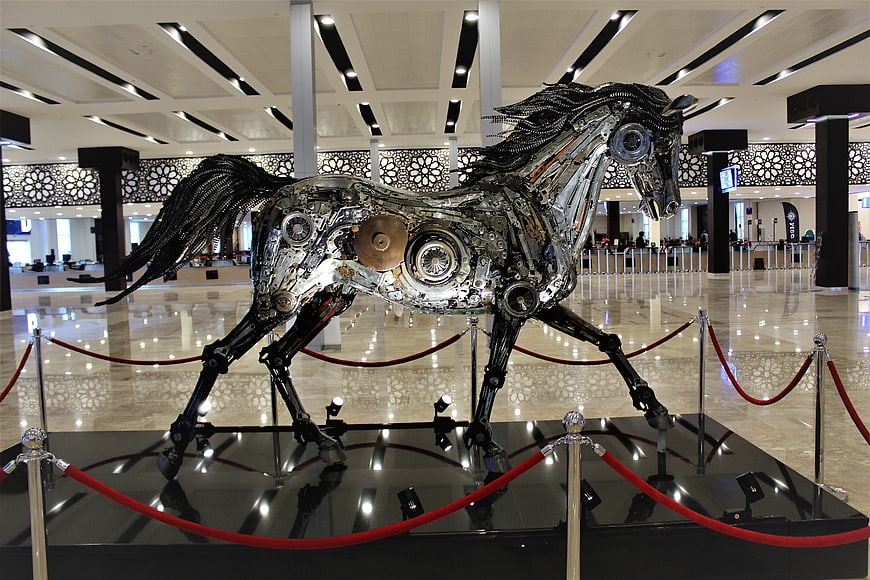 Metallic mechanical horse sculpture in modern lobby
