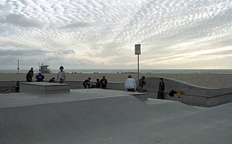Skateboarders at Venice Beach Skatepark with Ocean View