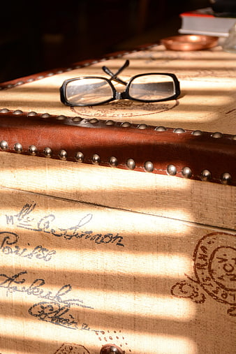 Vintage Glasses on Antique Trunk with Sunlight