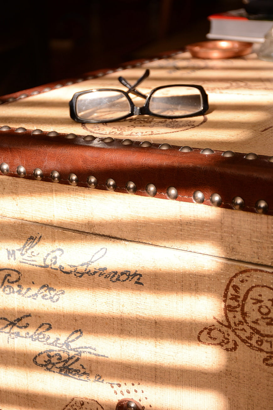 Vintage Glasses on Antique Trunk with Sunlight