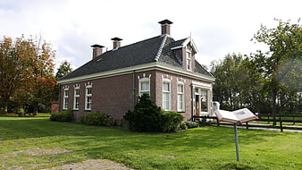 Traditional Dutch Brick House with Autumn Trees