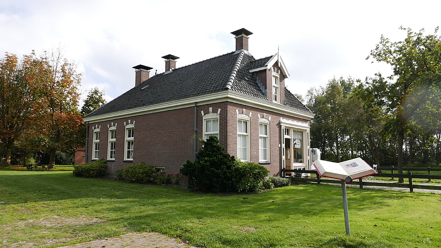Traditional Dutch Brick House with Autumn Trees