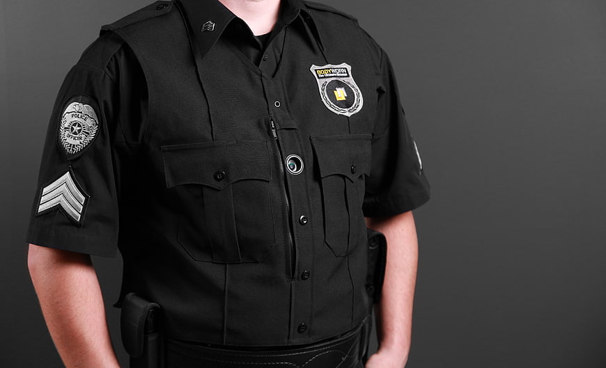 Police Officer Wearing Black Uniform And Body Camera
