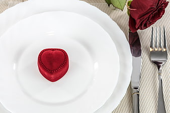 Red Heart-Shaped Ring Box on White Plate with Cutlery