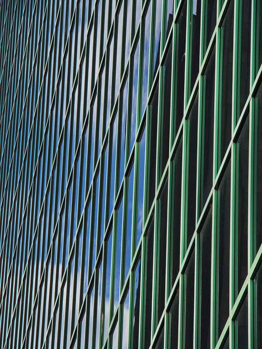 Abstract Green Glass Building Facade with Blue Sky Reflection