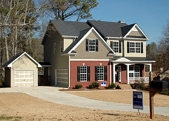 New two-story suburban home for sale with real estate sign