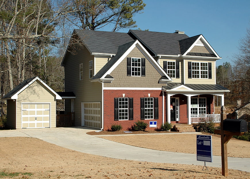 New two-story suburban home for sale with real estate sign