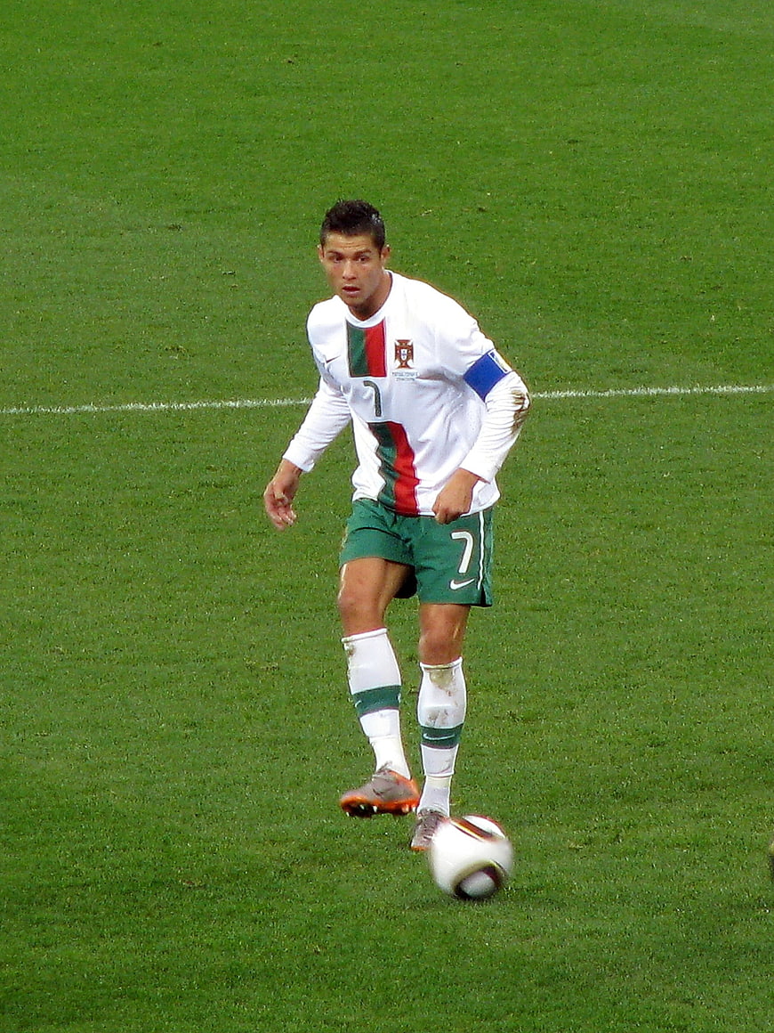 Cristiano Ronaldo dribbling soccer ball in Portugal kit