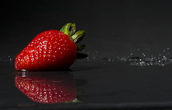 Fresh Red Strawberry on Black Surface with Water Splash