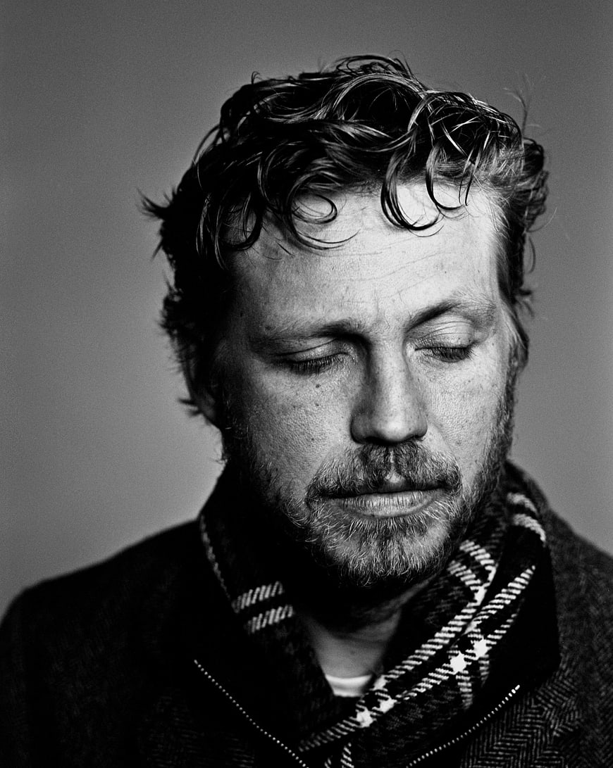 Black and white portrait of contemplative man with scarf