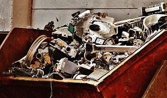 Scrap Metal and Auto Parts in Rusty Red Industrial Container