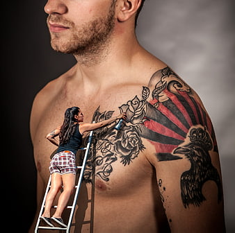 Surreal composite of woman painting giant tattoo on man