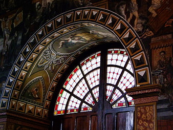 Ornate Arched Stained Glass Window in Historic Church Interior