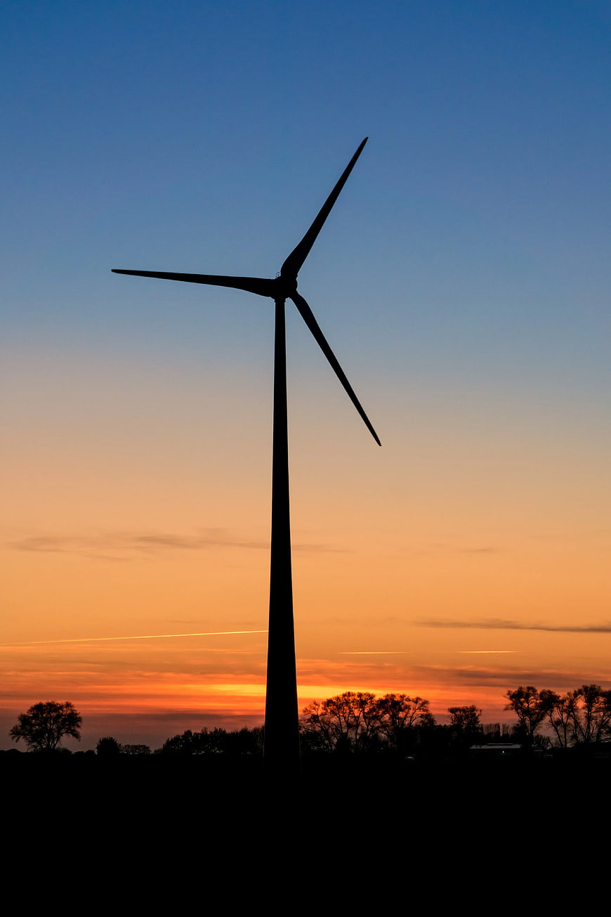 Wind Turbine Silhouette Against Vibrant Sunset Sky