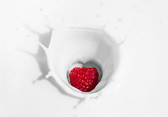 Raspberry Dropping Into Milk Splash On White Background