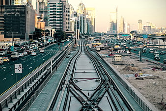 Elevated train tracks leading into Dubai city skyline