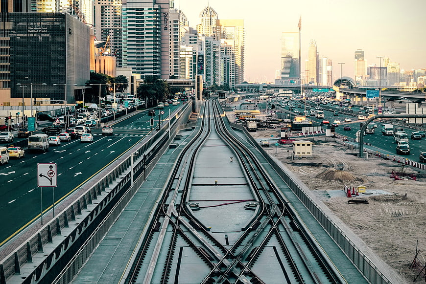 Elevated train tracks leading into Dubai city skyline