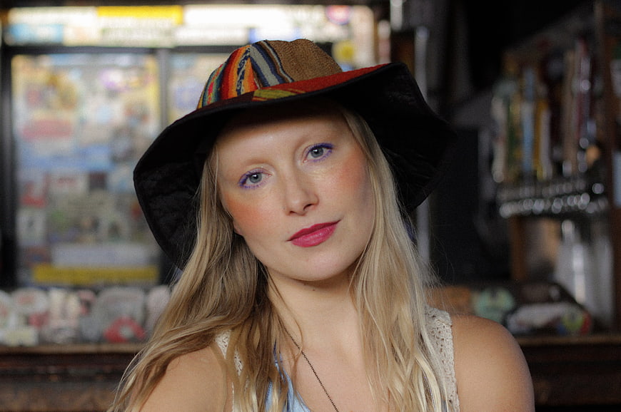 Portrait of Blonde Woman in Colorful Hat with Makeup