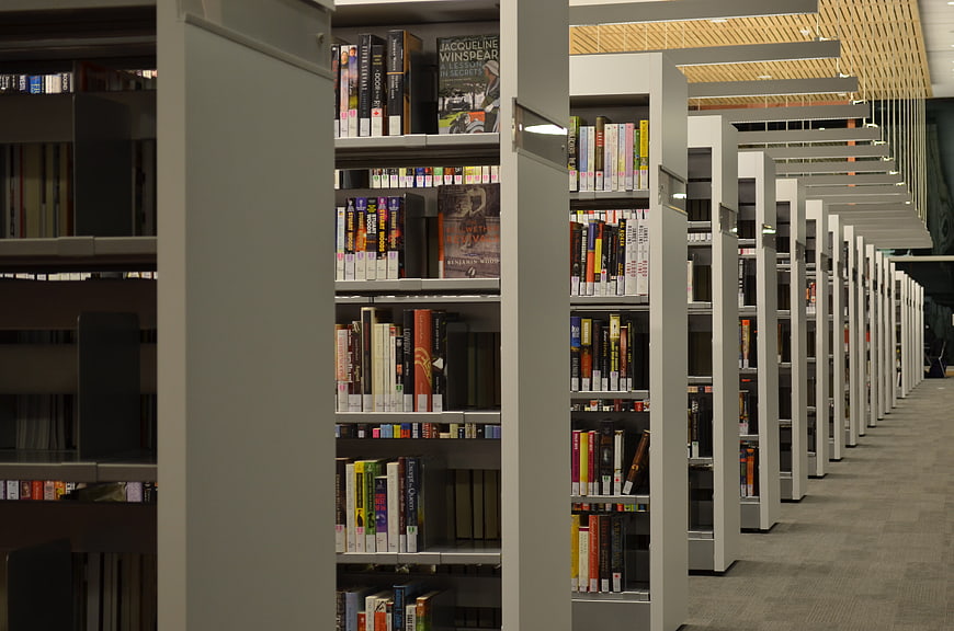 Modern university library interior with rows of bookshelves