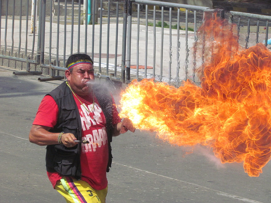 Man Breathing Fire at Outdoor Carnival Event