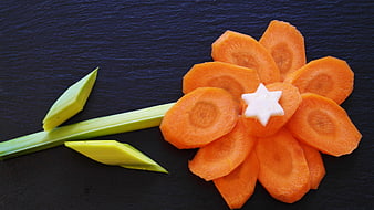 Creative Carrot Flower Garnish With Leek Stem On Dark Slate