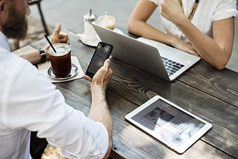 Business meeting at cafe with laptop and smartphone