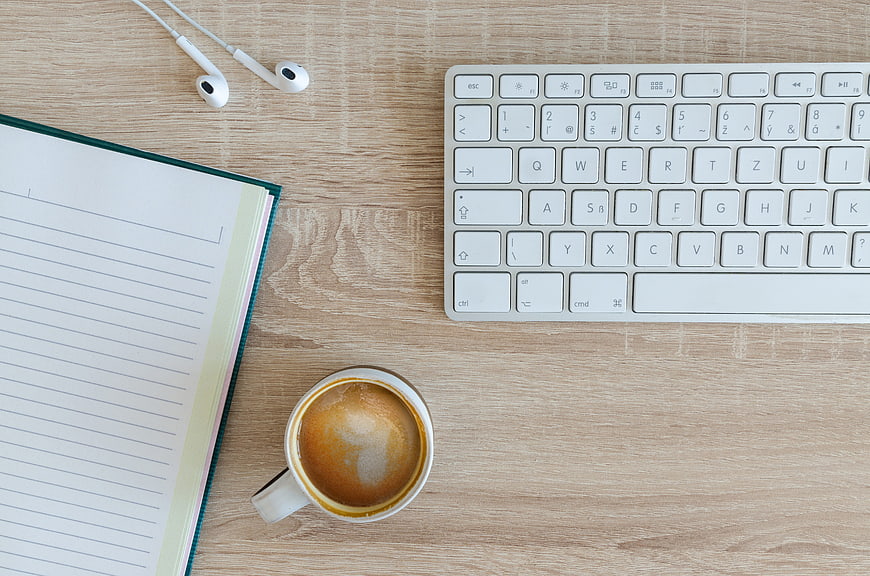 Top View Workspace with Keyboard, Coffee, and Notebook