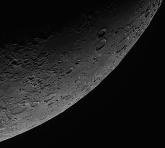 Close-up of Moon Surface with Craters and Shadows
