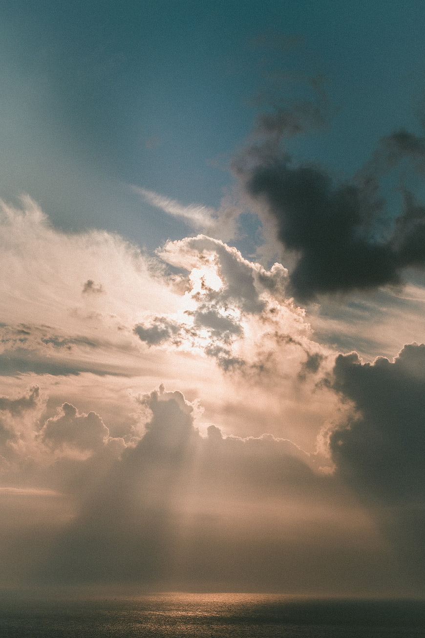 Dramatic Sun Rays Breaking Through Clouds Over Ocean