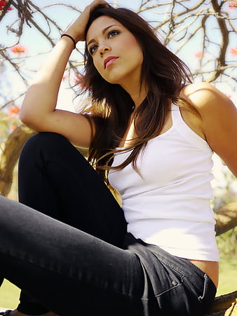 Beautiful Woman Sitting in Tree with Long Hair