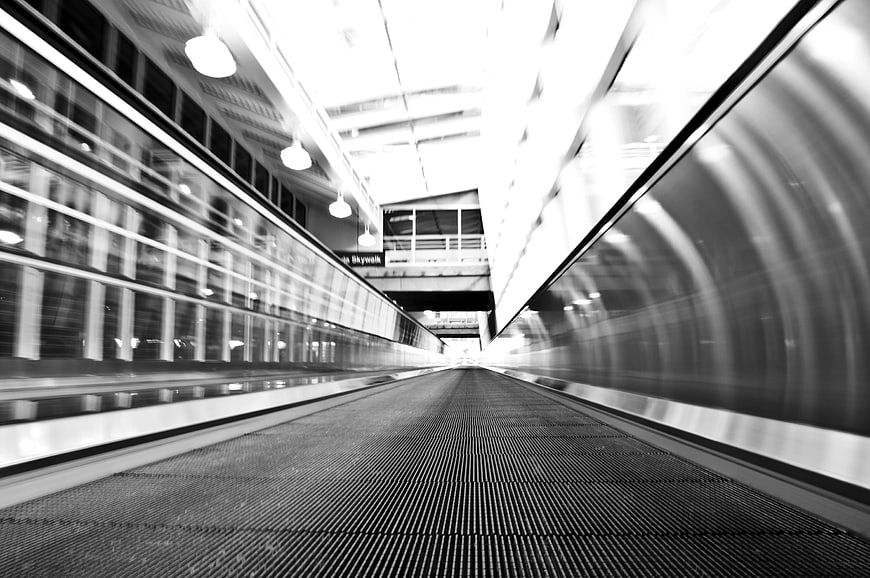 Motion blur black and white moving walkway perspective