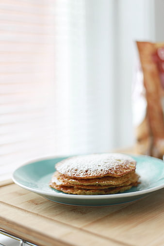 Stack of Pancakes with Powdered Sugar on Blue Plate
