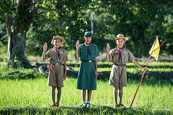 Three Thai Scouts Saluting in Green Field