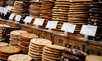 Stacks of assorted cookies at a bakery market stall