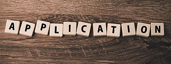 Scrabble Tiles Spelling Application on Wooden Background