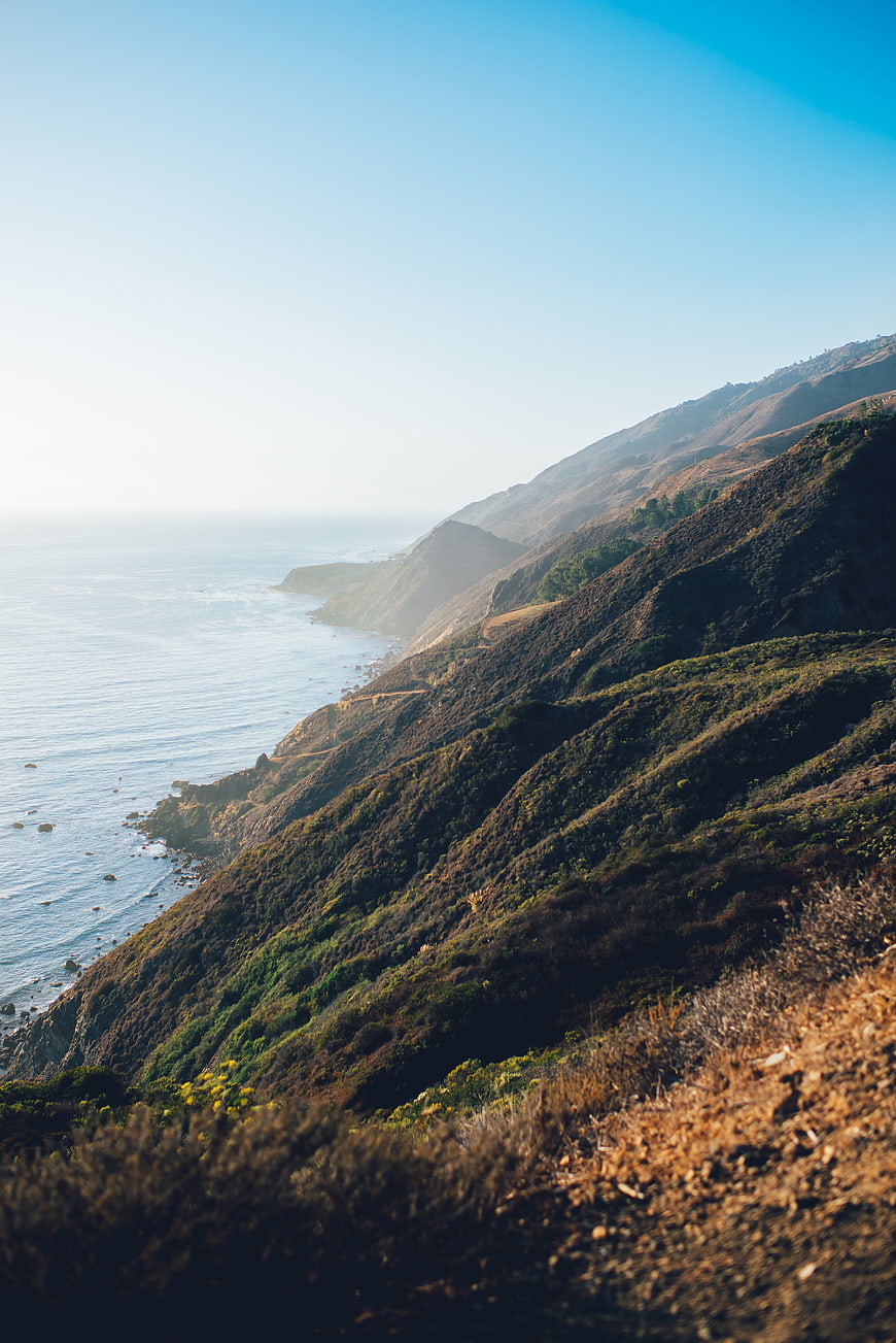 Scenic coastal landscape with rolling hills and ocean view
