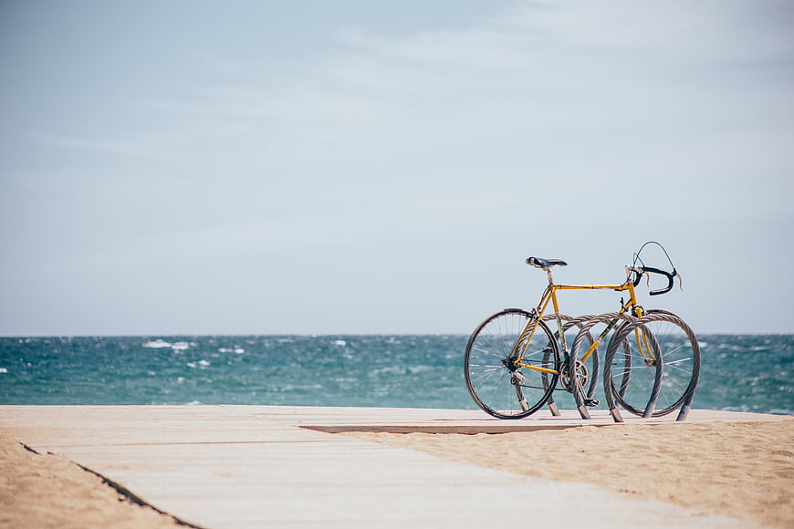 Yellow Bicycle on Wooden Boardwalk by Ocean