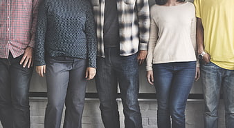 Group of friends standing together in casual jeans and shirts